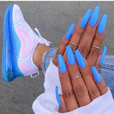 a woman's hand with bright blue nails