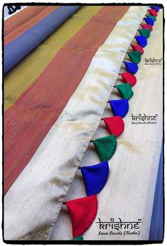 colorful fabric with tassels laid out on it