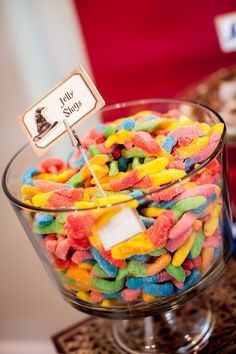 a glass bowl filled with lots of colorful candy