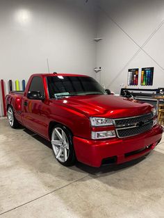 a red pickup truck parked in a garage