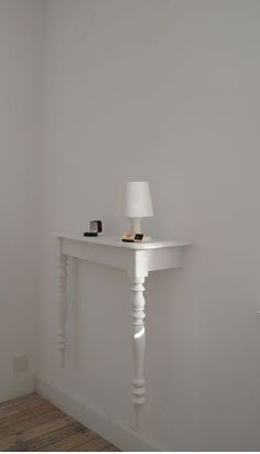 a white table with a lamp on top of it