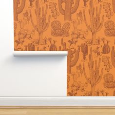 an orange wallpaper with cacti on it