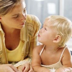 a woman and child are looking at each other