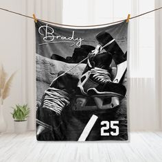 a black and white photo of a hockey player on a wall hanging from a rope