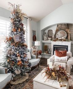 a living room decorated for christmas with a tree in the corner and other holiday decorations