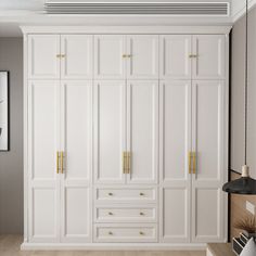 a white closet with gold handles and drawers in a living room or office space,