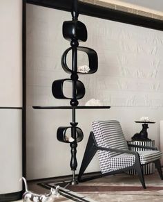 a black and white living room with modern furniture in the corner, including a chair