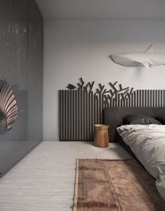 a bedroom with a large bed and decorative wall art on the walls, along with an area rug