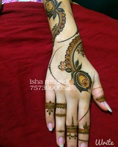 a woman's hand with henna tattoos on it