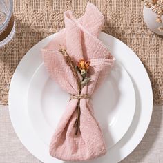 a white plate topped with a pink napkin