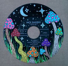 a black record with colorful mushrooms and stars on it