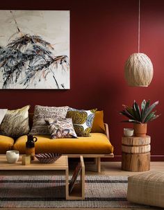 a living room filled with furniture and a painting on the wall above it's coffee table