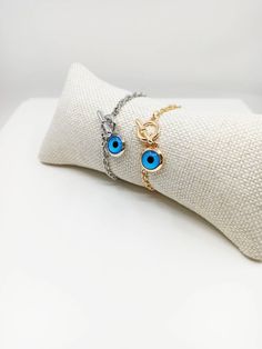 Blue eye jewelry is tarnish resistant,can't be faded in a long time. The lenght of the nazar bracelet is 18 cm(7 in) Evil eyes are believed to protect the person who carries them. They are also believed to bring good luck and deflect the negative energy. Evil eye charm bracelet can be a perfect gift choice for Christmas or birthday. 🌀Evil eye charm is over 5000 years old. It is found in all major religions and cultures. Blue evil eye or lucky evil eye is a Mediterranean amulet for protection ag Blue Evil Eye Bracelet With Adjustable Chain, Metal Charm Bracelet With Evil Eye, Blue Round Evil Eye Bracelets, Blue Evil Eye Round Bracelets, Evil Eye Metal Charm Bracelet, Blue Metal Spiritual Bracelets, Spiritual Blue Metal Bracelets, Blue Metal Bracelets With Evil Eye, Blue Metal Bracelet With Evil Eye