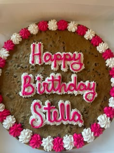 a birthday cake with the words happy birthday stella spelled in pink and white frosting