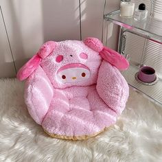 a pink pig chair sitting on top of a white rug