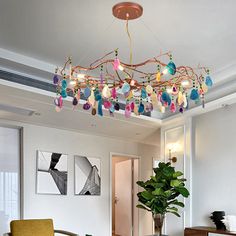 a living room filled with furniture and a chandelier hanging over the top of it