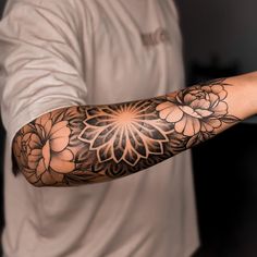 a man with a flower tattoo on his arm