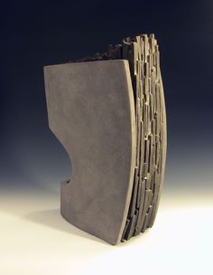 a sculpture made out of concrete on a white surface