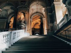 the stairs lead up to an ornate building