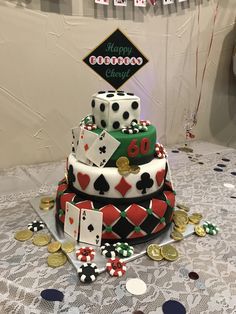 a multi layer cake decorated with playing cards and casino chips