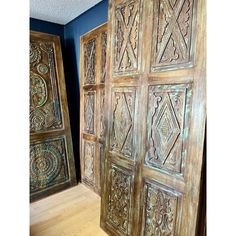 two wooden doors with intricate carvings on them