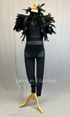 a mannequin with black feathers on it's head and leggings