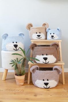 three crocheted bear baskets with plants in them