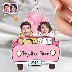 a couple in a pink car keychain with the words together since on it