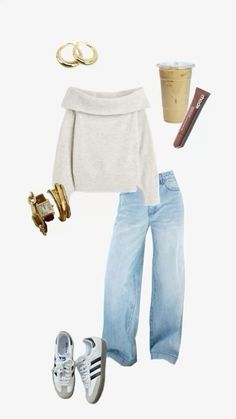 a white sweater, jeans and sneakers are arranged in the shape of a woman's outfit