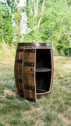 two wooden barrels sitting in the grass