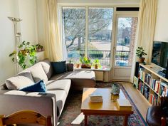 a living room filled with furniture and a flat screen tv sitting on top of a wooden table