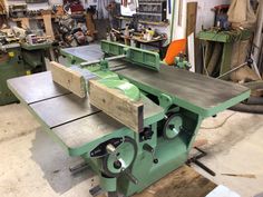 a table sawing in a shop with lots of tools