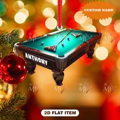 a pool table ornament hanging from a christmas tree