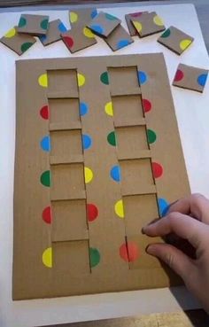 someone is making a cardboard board with dots on it