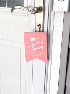 a pink sign that says shr sleeping baby on it's door hanger