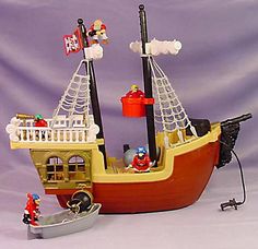 a lego pirate ship is shown on a purple background with other toys and accessories around it