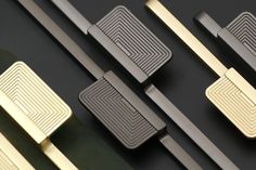 several different types of handles on a black surface with gold and silver trimmings