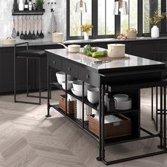 a large kitchen island with lots of counter space and plates on the table in front of it