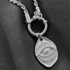 “Eye Of The Sky” Sun Sunburst Sunrays Sunshine Sunbeam Eye Of Ra Eye Of Re Ancient Egyptian God Evil Eye Nazar Mati Protection Amulet Psychic Tarot Fortune Teller Witchy Celestial Cosmos Galaxy Universe Space Astronomy Astrology O-Ring Toggle Clasp Silver Stainless Steel Necklace. Unique Irregular Shaped Pendant With Wavy Borders, Like That Of A Flattened Coin, With A Central Eyeball Or Evil Eye. Portions Of The Eye Are Incorporated With Carved Bursting Sunrays/Sunbeams/Outward Radiating Lines T Eye Of Re, Cosmos Galaxy, Eyeball Necklace, Radiating Lines, Metal Evil Eye Necklace With Round Shape, Eye-shaped Amulet Necklace As Gift, Adjustable Evil Eye Amulet Necklace, Spiritual Metal Evil Eye Necklace, Galaxy Universe