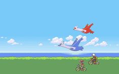 an airplane flying over a man riding a bike on top of a grass covered field