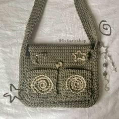 a crocheted purse with two eyes on the front and one in the back