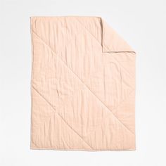 an unmade quilted blanket on a white background