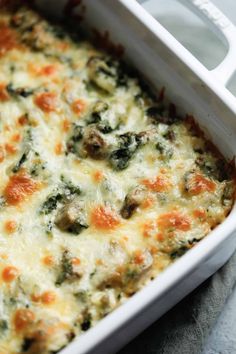 a casserole dish with cheese and spinach