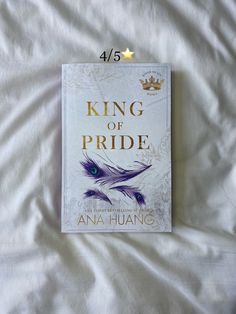 a book with the title king of pride written in gold on top of white sheets