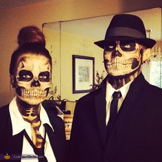 two people dressed up in skeleton makeup posing for the camera with one man wearing a suit and tie