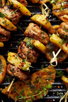 grilled meat and pineapple skewers on a grill with garnishes