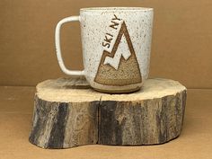 a coffee cup sitting on top of a tree stump