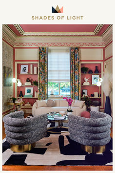 a living room filled with lots of furniture next to a window covered in colorful curtains