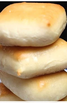 a stack of four doughnuts sitting on top of a blue and white plate