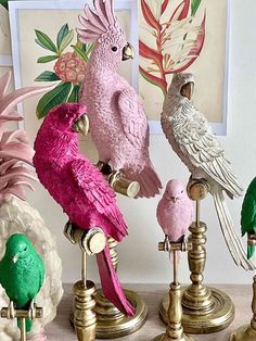 there are many different colored birds on this stand